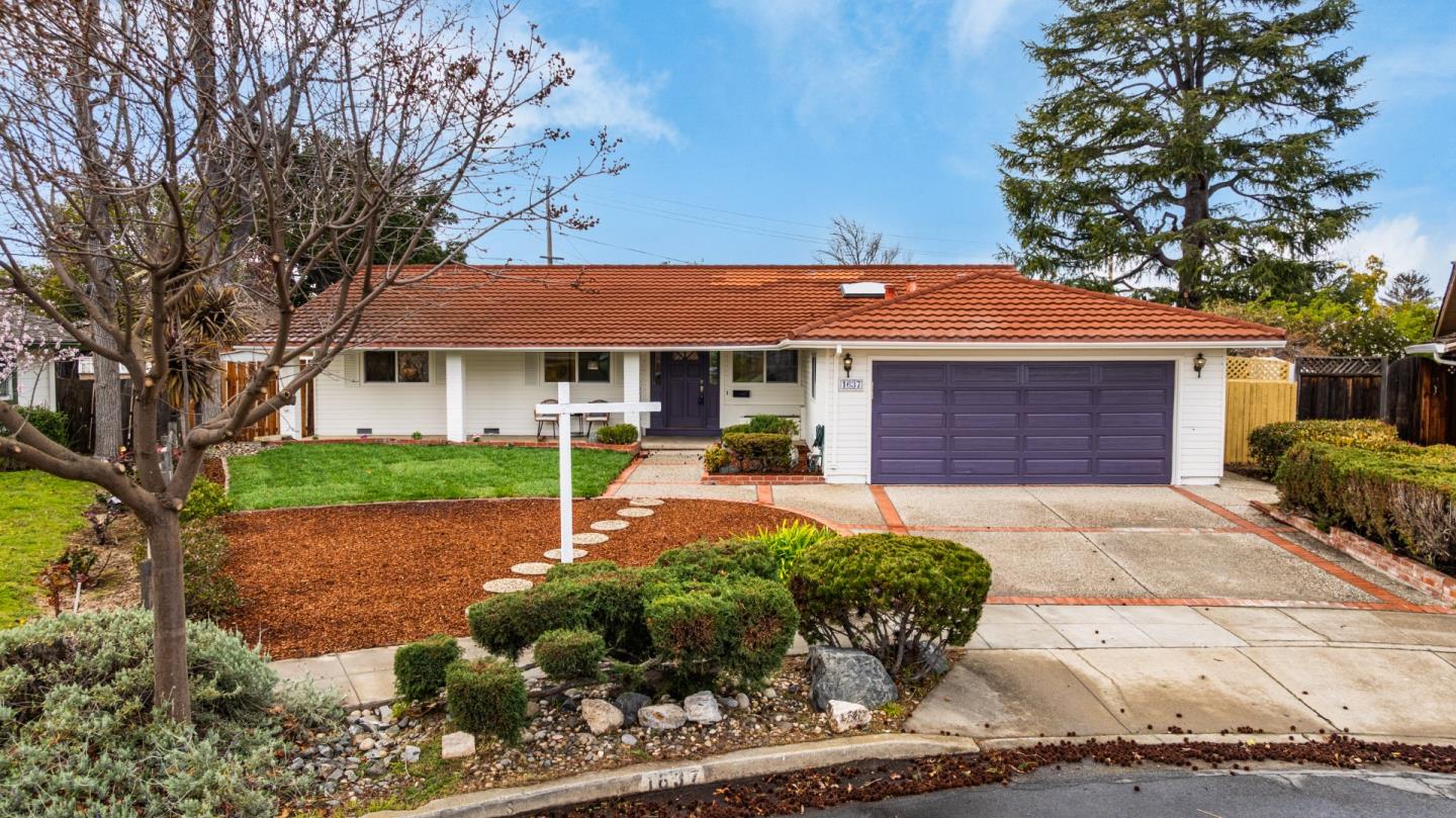1637 Kitchener Drive Sunnyvale, CA 94087 - Photo 52 of 57 a front view of a house with a yard and garage