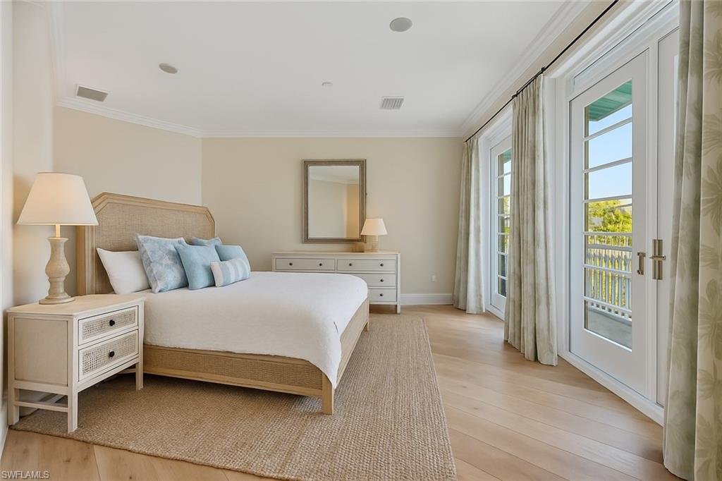 1001 10th Avenue South, Unit C1 Naples, FL 34102 - Photo 11 of 38 a bedroom with a bed and a large window