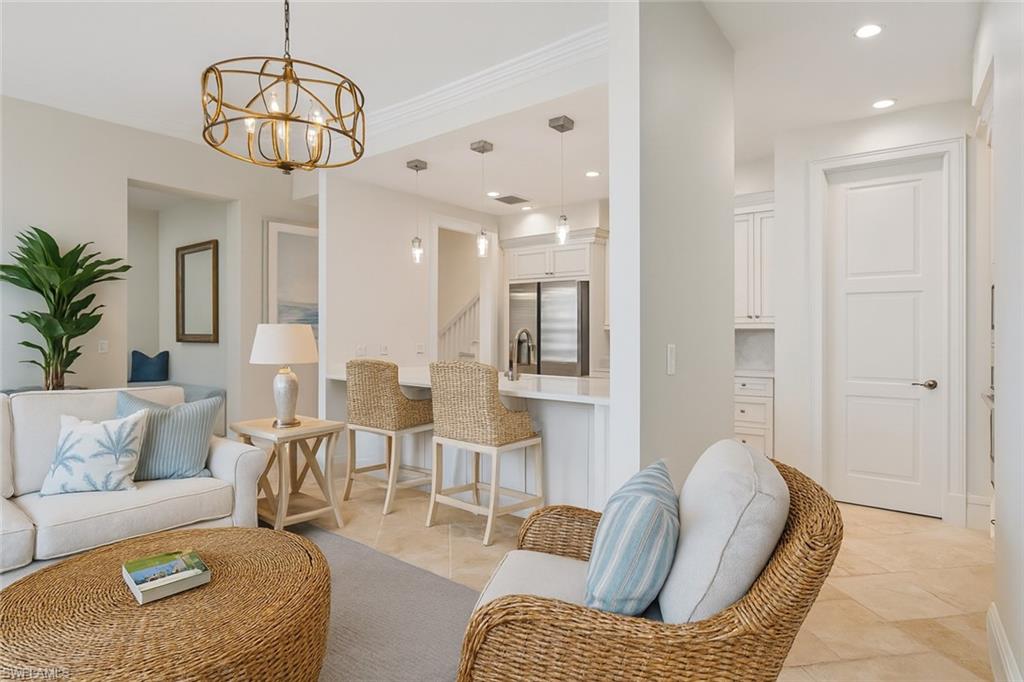 1001 10th Avenue South, Unit C1 Naples, FL 34102 - Photo 20 of 38 a living room with furniture and a chandelier