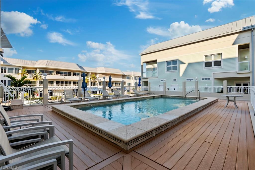 1001 10th Avenue South, Unit C1 Naples, FL 34102 - Photo 24 of 38 a view of swimming pool with a lounge chairs