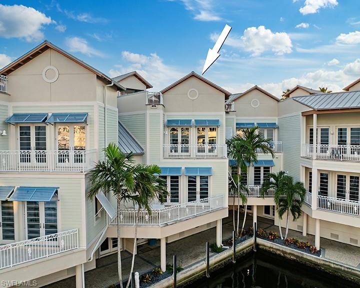 1001 10th Avenue South, Unit C1 Naples, FL 34102 - Photo 3 of 38 a view of a house with a swimming pool and furniture