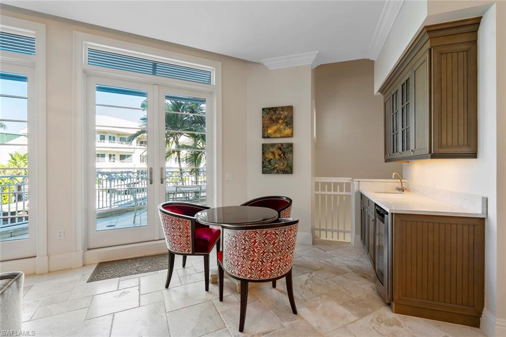 1001 10th Avenue South, Unit C1 Naples, FL 34102 - Photo 32 of 38 a living room with furniture and a window