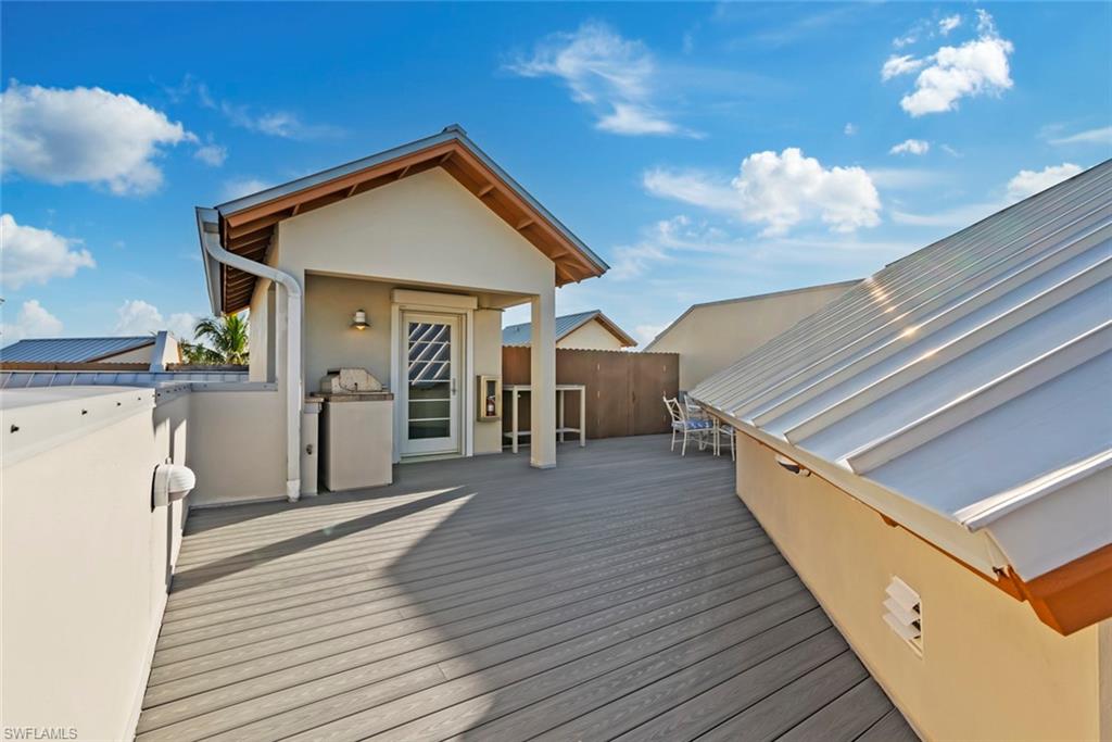 1001 10th Avenue South, Unit C1 Naples, FL 34102 - Photo 35 of 38 a view of a house with wooden deck
