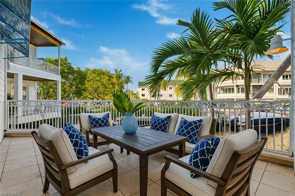 1001 10th Avenue South, Unit C1 Naples, FL 34102 - Photo 8 of 38 a view of a patio with couple of chairs and a table
