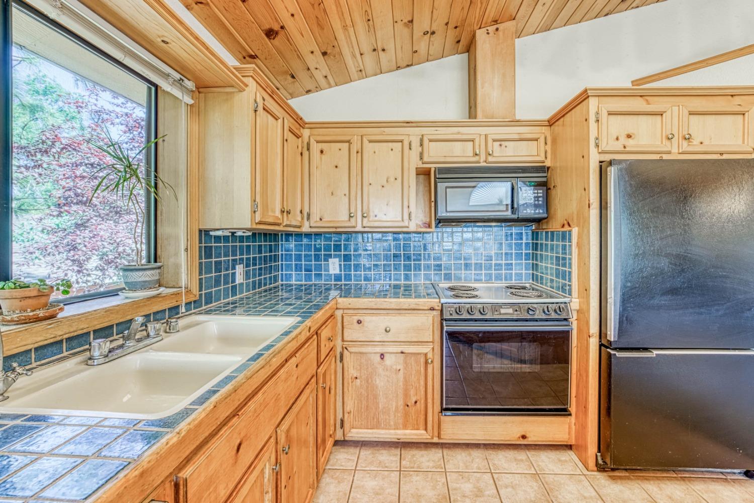 34075 Shaver Springs Road Auberry, CA 93602 - Photo 13 of 41 a kitchen with stainless steel appliances granite countertop a sink and cabinets