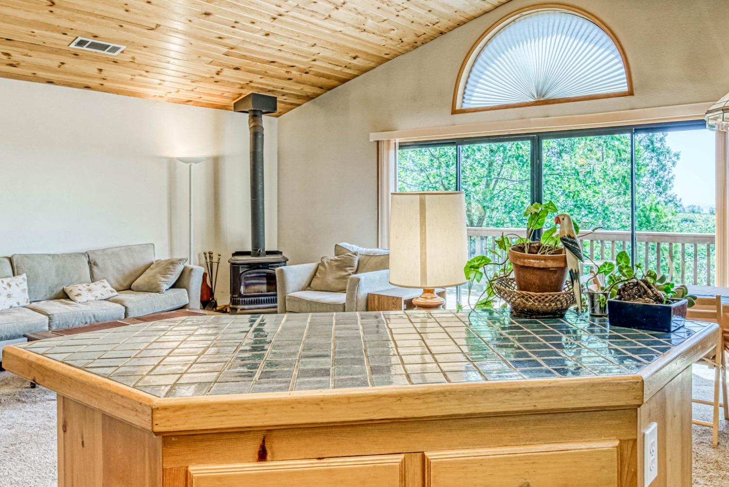 34075 Shaver Springs Road Auberry, CA 93602 - Photo 14 of 41 a living room with granite countertop a couch and a table