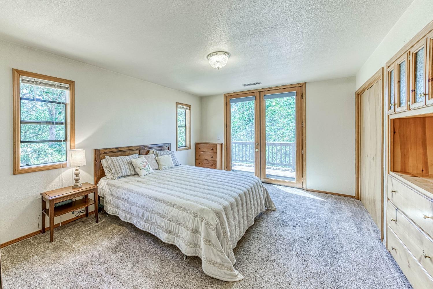 34075 Shaver Springs Road Auberry, CA 93602 - Photo 23 of 41 a bedroom with a large bed and a window