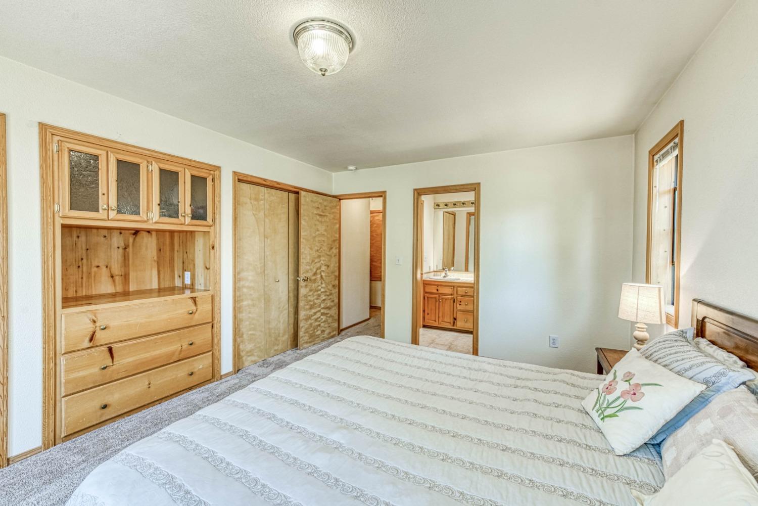 34075 Shaver Springs Road Auberry, CA 93602 - Photo 24 of 41 a bedroom with a bed and a dresser