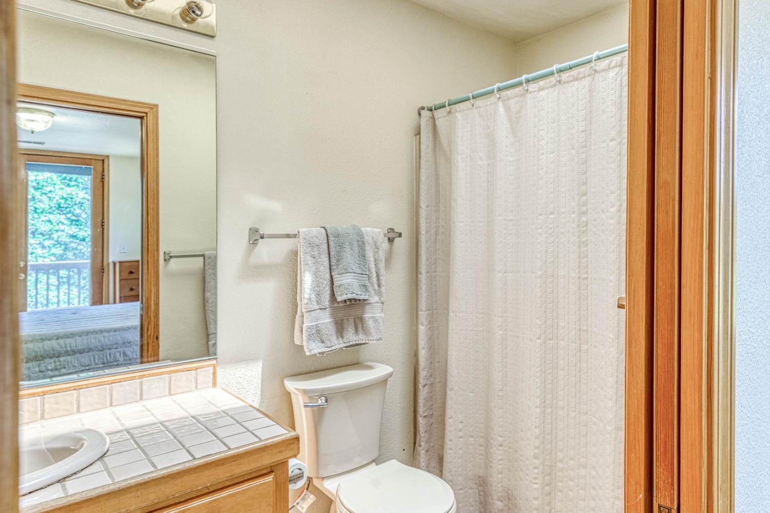 34075 Shaver Springs Road Auberry, CA 93602 - Photo 25 of 41 a bathroom with a sink toilet and shower