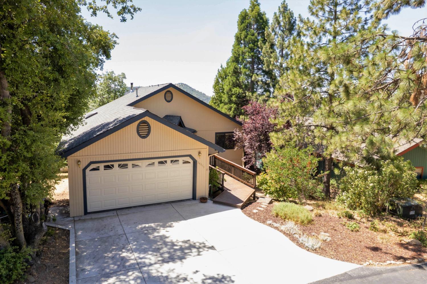 34075 Shaver Springs Road Auberry, CA 93602 - Photo 30 of 41 a view of a large white house with a large tree