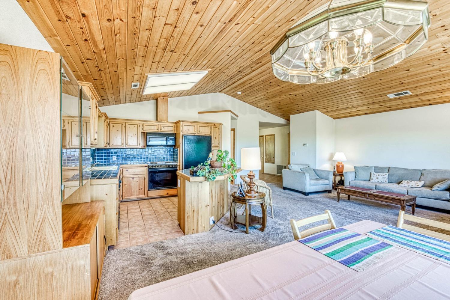 34075 Shaver Springs Road Auberry, CA 93602 - Photo 9 of 41 a living room with furniture and a chandelier