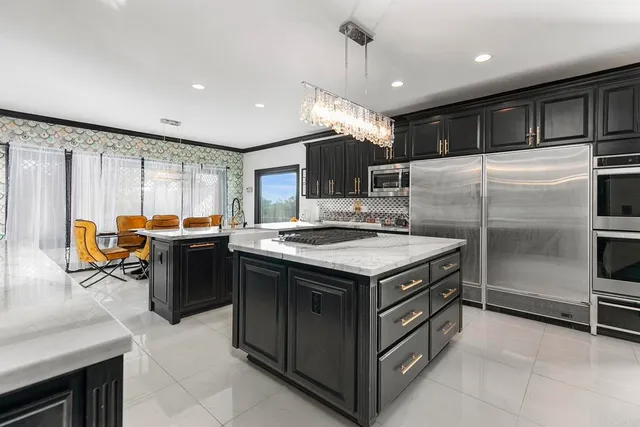a kitchen with stainless steel appliances granite countertop a stove and a sink