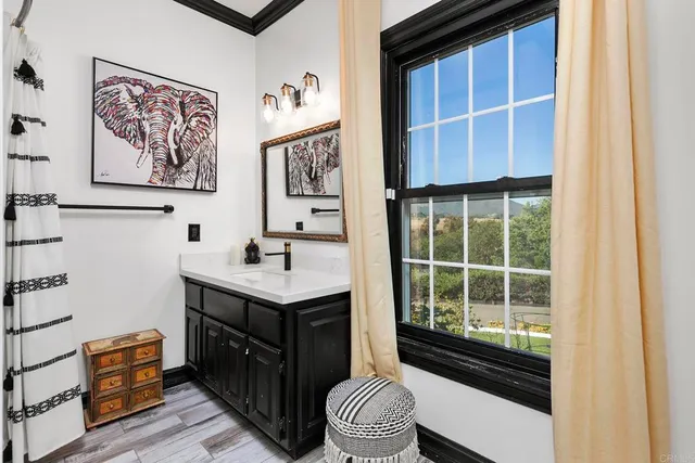 a bathroom with a double vanity sink and a large mirror