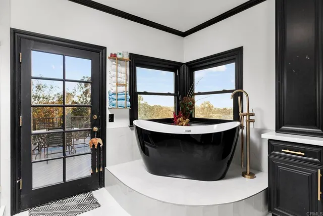 a backyard of a house with a yard and outdoor seating