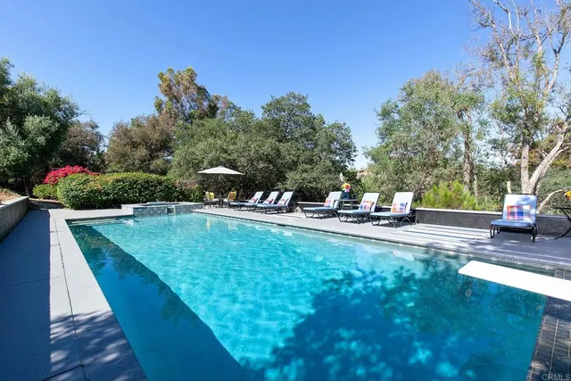 a front view of a house with a yard table and chairs