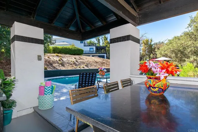 a view of a swimming pool with a table and chairs