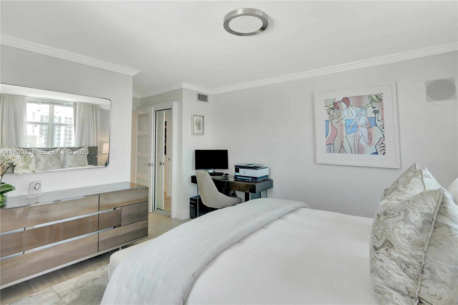 720 Collins Avenue, Unit PH1 Miami Beach, FL 33139 - Photo 14 of 27 a bedroom with a bed and a chandelier