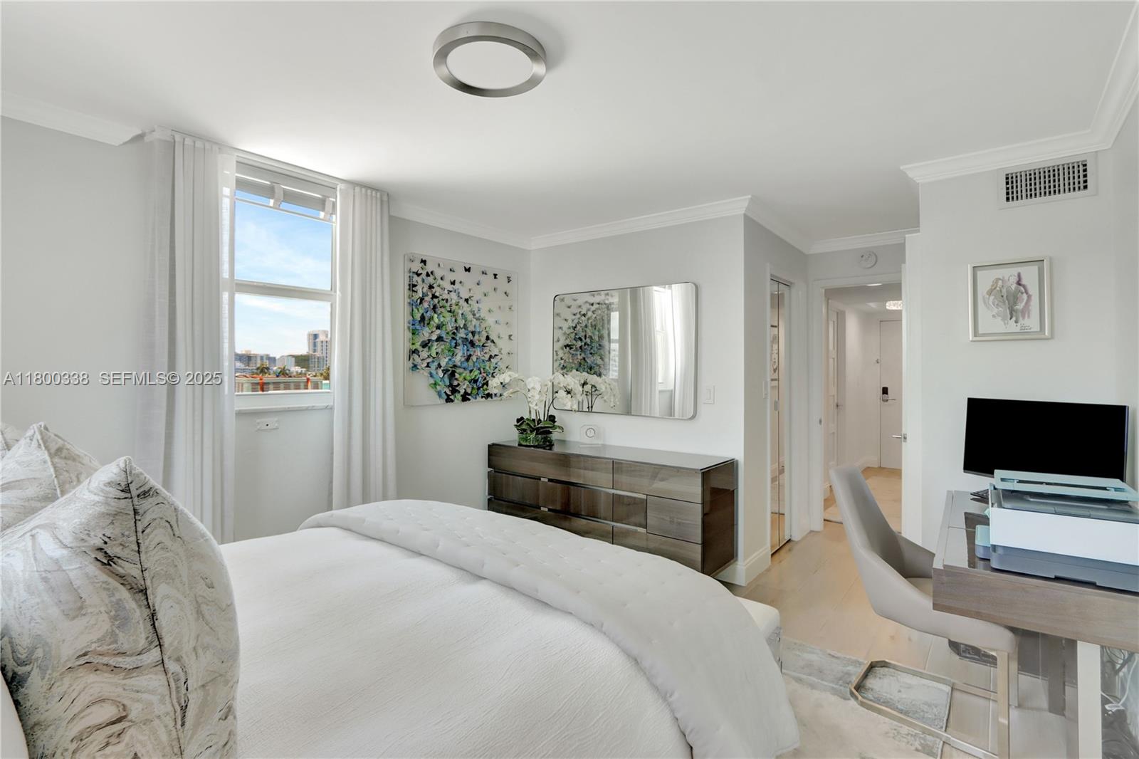 720 Collins Avenue, Unit PH1 Miami Beach, FL 33139 - Photo 15 of 27 a bedroom with a bed and a flat screen tv