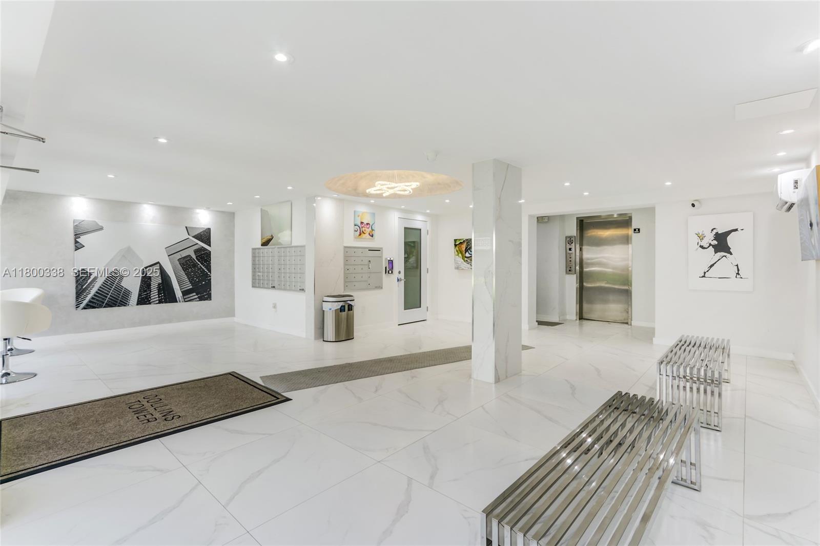 720 Collins Avenue, Unit PH1 Miami Beach, FL 33139 - Photo 20 of 27 a spacious bathroom with a large mirror vanity and shower
