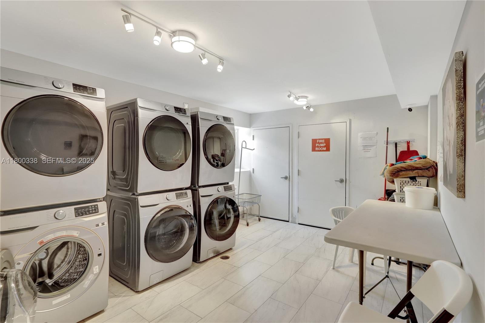 720 Collins Avenue, Unit PH1 Miami Beach, FL 33139 - Photo 25 of 27 a view of a storage and utility room with washer and dryer