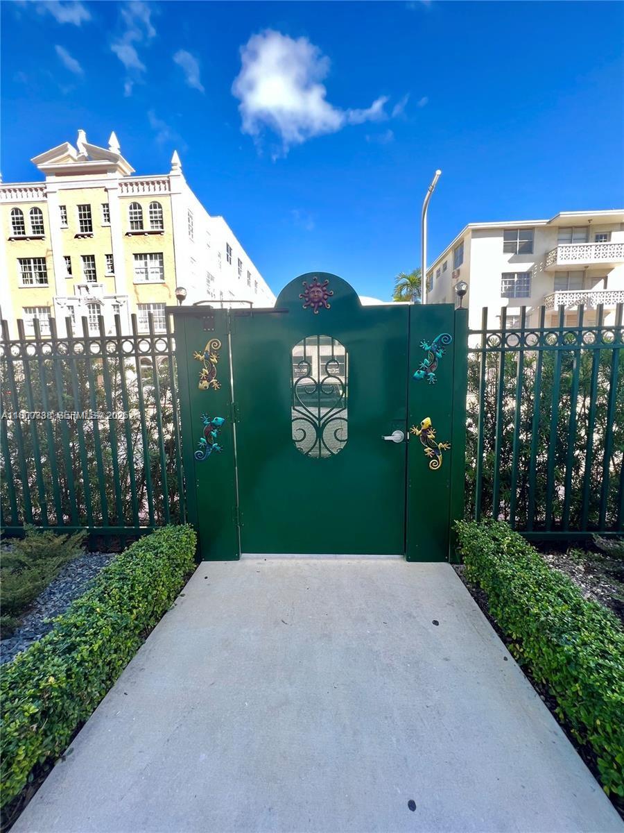 720 Collins Avenue, Unit PH1 Miami Beach, FL 33139 - Photo 27 of 27 a view of a large building with a yard and plants