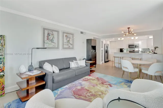 a living room with furniture and kitchen view
