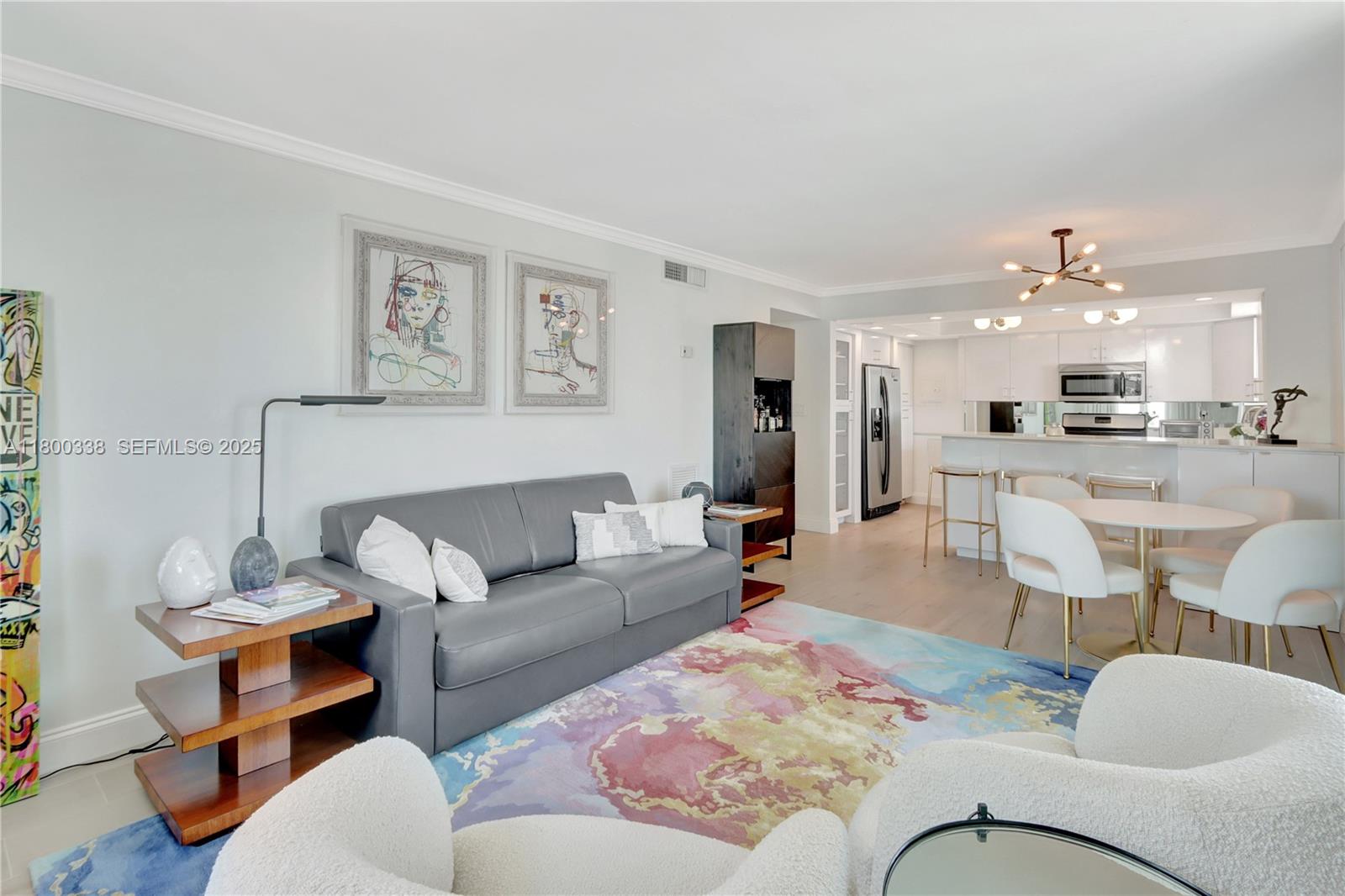 720 Collins Avenue, Unit PH1 Miami Beach, FL 33139 - Photo 5 of 27 a living room with furniture and kitchen view