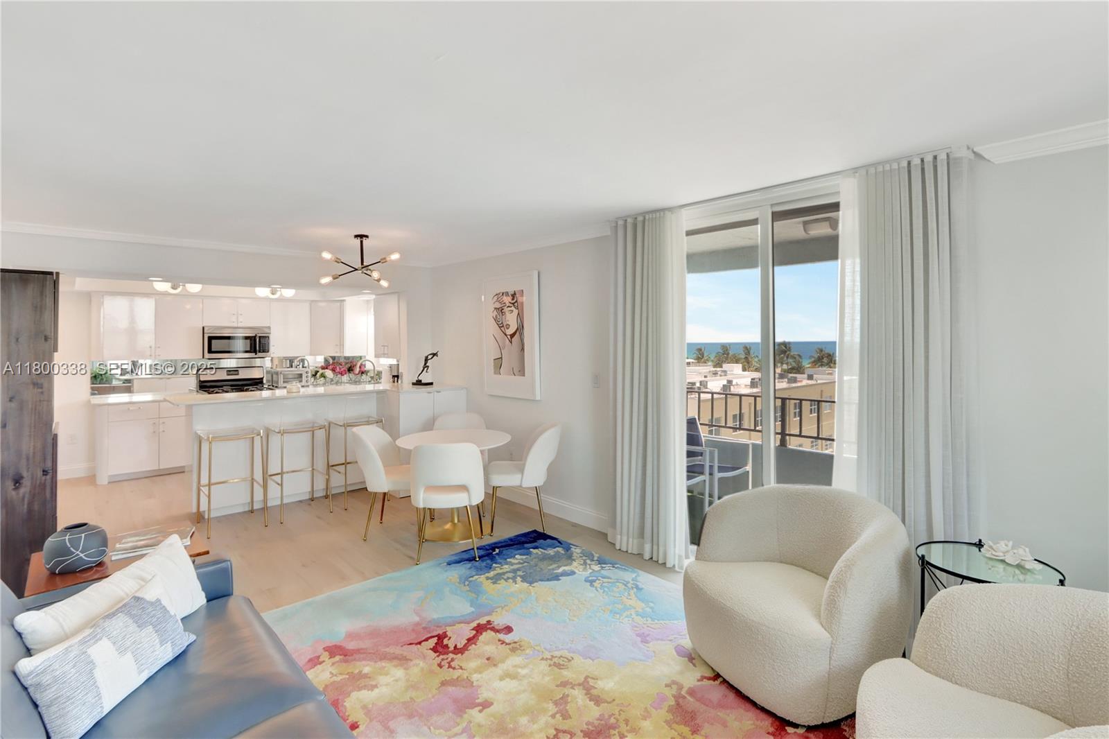 720 Collins Avenue, Unit PH1 Miami Beach, FL 33139 - Photo 6 of 27 a living room with furniture and a large window