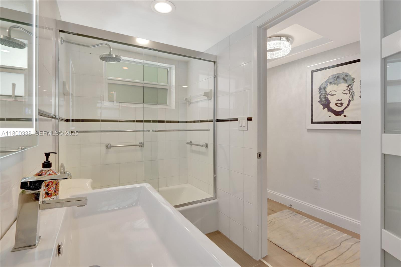 720 Collins Avenue, Unit PH1 Miami Beach, FL 33139 - Photo 10 of 27 a bathroom with a bathtub and a shower