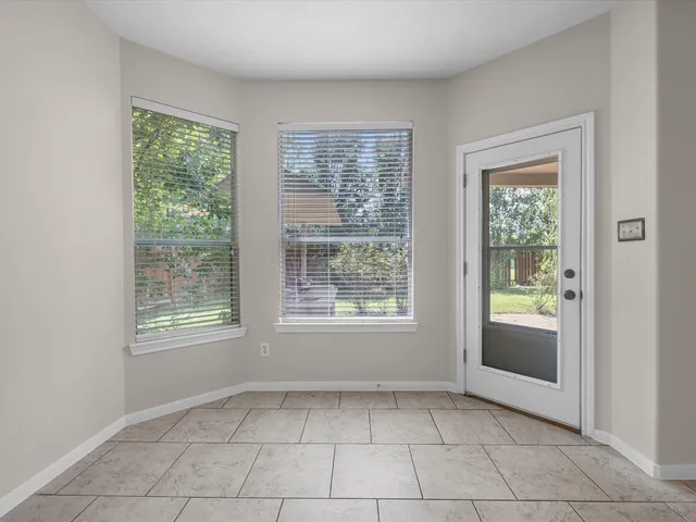 an empty room with a outdoor view and window