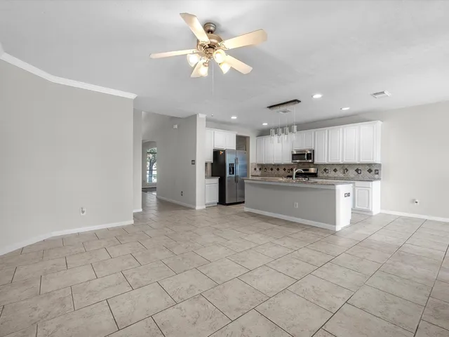 a view of kitchen refrigerator and microwave