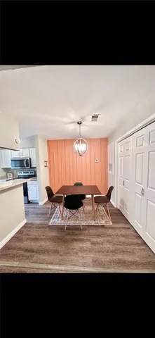 a view of kitchen and kitchen with granite countertop