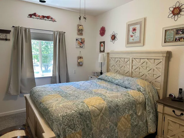 a bedroom with a bed and a window