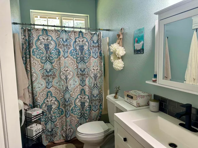 a white toilet sitting next to a bathroom sink