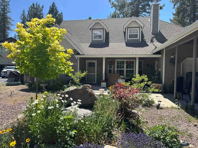 a view of a house with potted plants