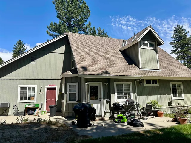 a front view of a house with swimming pool and sitting area