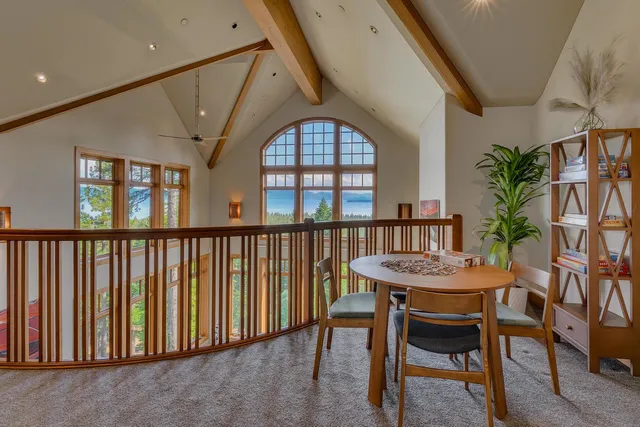 a dining room with furniture potted plants and wooden floor