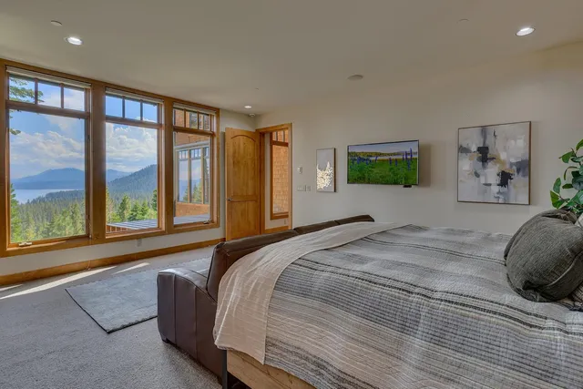 a bed sitting in a bedroom next to a large window