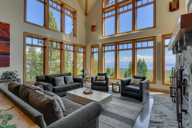 a living room with furniture fireplace furniture and a large window