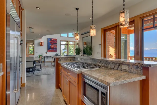 a kitchen that has a stove a sink and a table in it