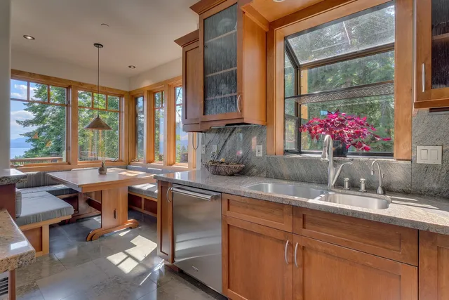 a kitchen with a sink and large windows