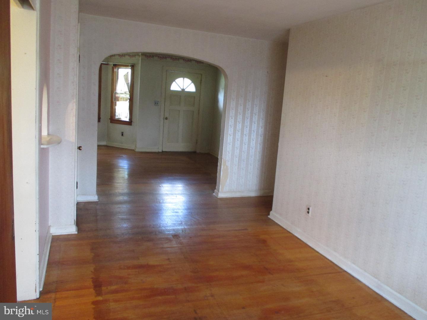 97 Schoolhouse Road Carneys Point, NJ 08069 - Photo 4 of 25 an empty room with wooden floor and windows