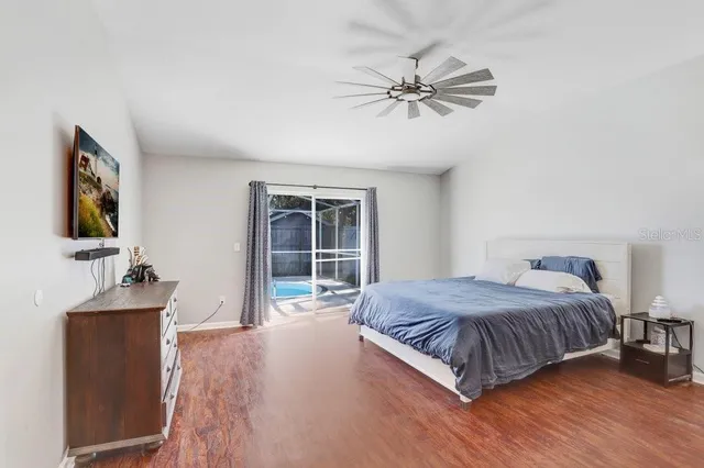 a bedroom with a large bed and a chandelier