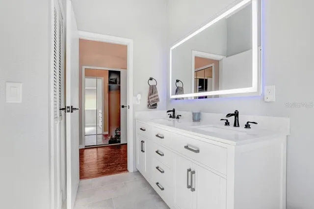 a bathroom with a sink vanity toilet and shower