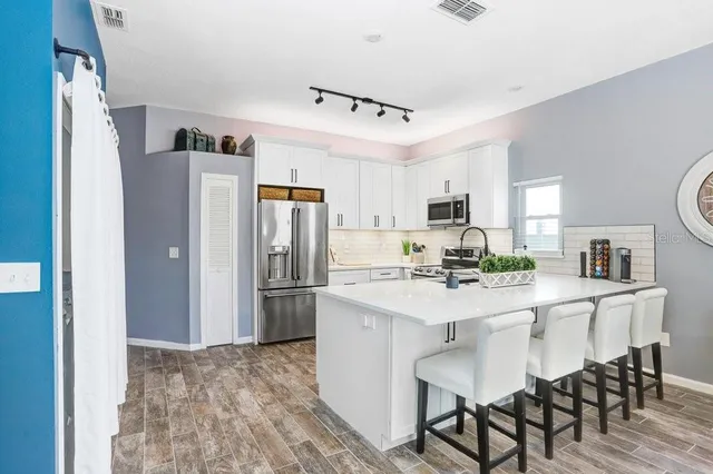 a kitchen with stainless steel appliances a refrigerator stove microwave and cabinets