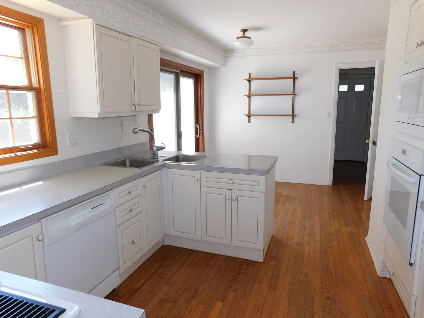 213 Weidner Road Buffalo Grove, IL 60089 - Photo 2 of 15 a kitchen with sink cabinets and wooden floor