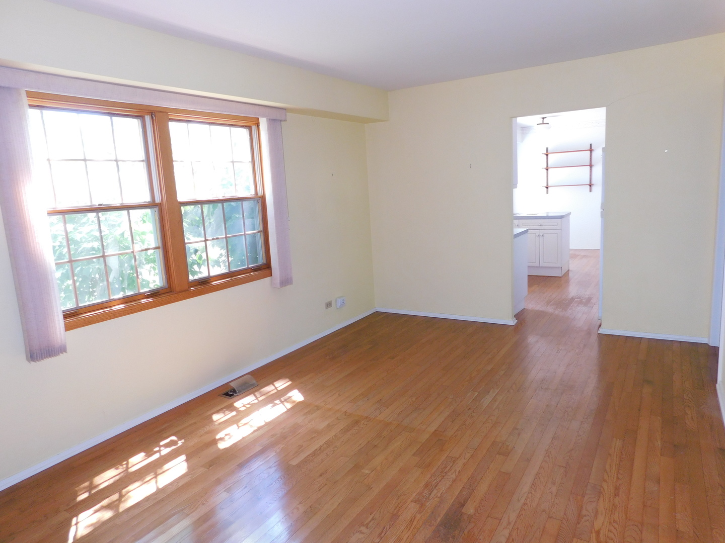 213 Weidner Road Buffalo Grove, IL 60089 - Photo 6 of 15 a view of empty room with wooden floor and fan