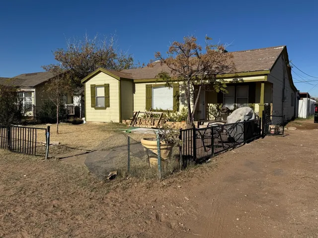 a view of a house with barbeque grill and couches
