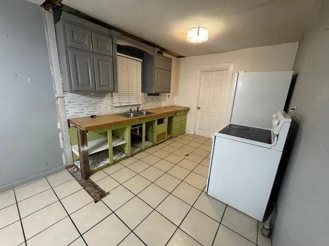 a kitchen with a sink and a stove top oven