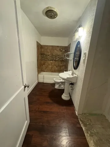 a bathroom with a toilet and a mirror